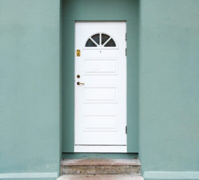 Green pastel wall with white door